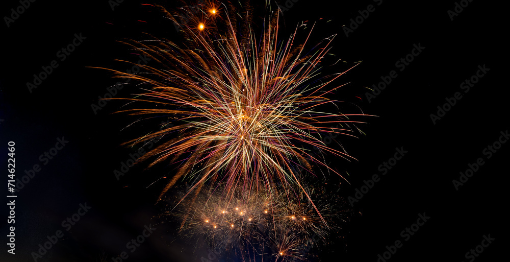 Colorful celebration fireworks isolated on a black sky background.Abstract and brightly firework in the celebration and anniversary festival.Merry Christmas and New year party light on night sky.