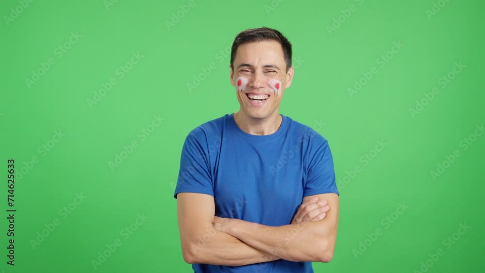 Man standing with japanese flag painted on face smiling