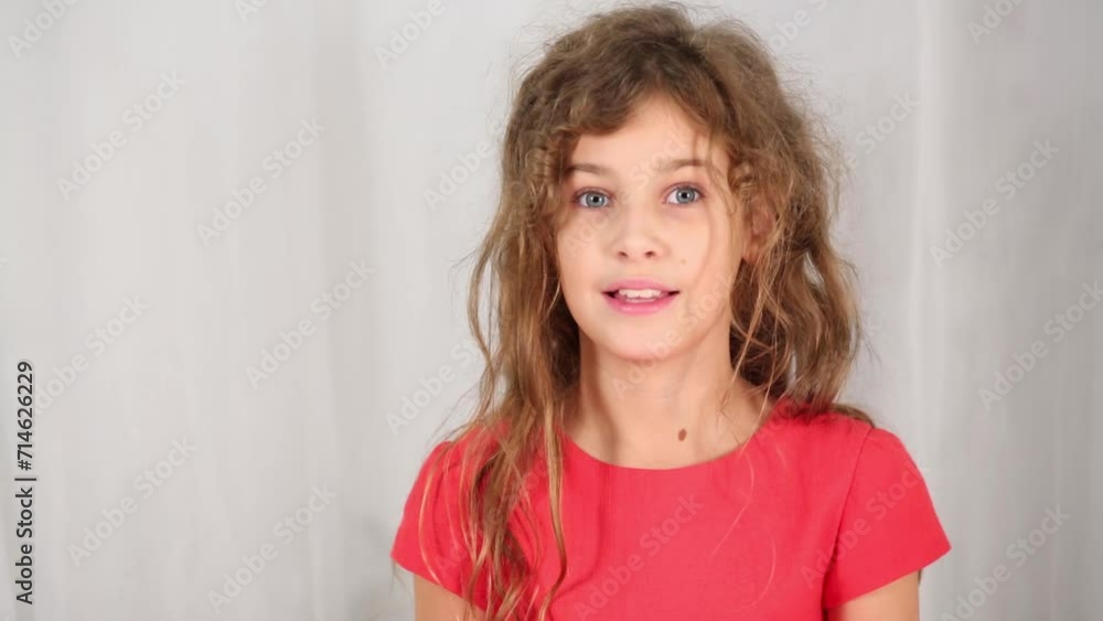 Pretty girl in red with tousled hair smile in white studio Pretty girl in red with tousled hair smile in white studio