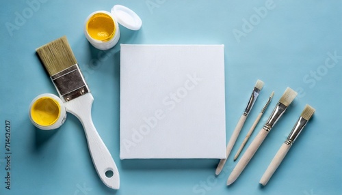 blank canvas tubes of oil paints and spatula on light blue background flat lay space for text photo