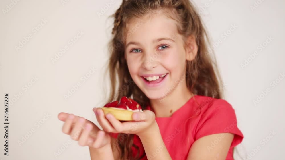 Pretty girl holds small pie, poses and laughs in white studio Pretty girl holds small pie, poses and laughs in white studio