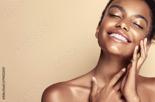 Beauty portrait of African American girl . Beautiful black woman touch her face . Facial  treatment . Cosmetology , skin care  and spa . 
