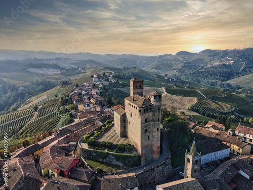 the castle of serralunga d'alba taken from a drone with a view from above during a spectacular sunset with the bright colors of autumn 2023