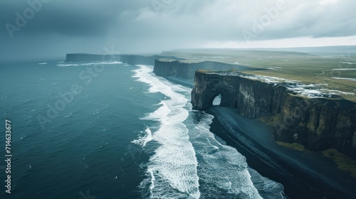  an aerial view of a large body of water next to a large cliff with a tunnel in the middle of it and a large body of water in the foreground.