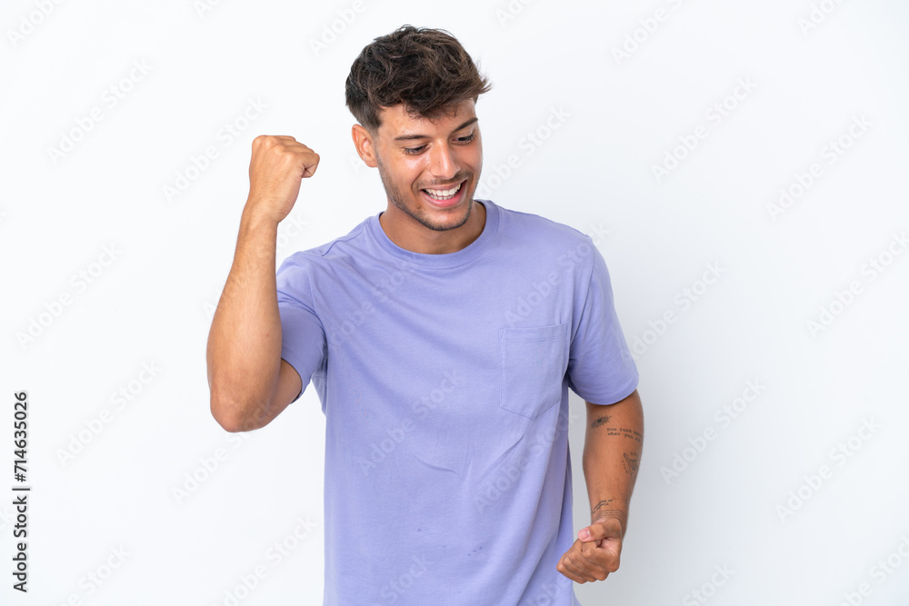 Young caucasian handsome man isolated on white background celebrating a victory Young caucasian handsome man isolated on white background celebrating a victory