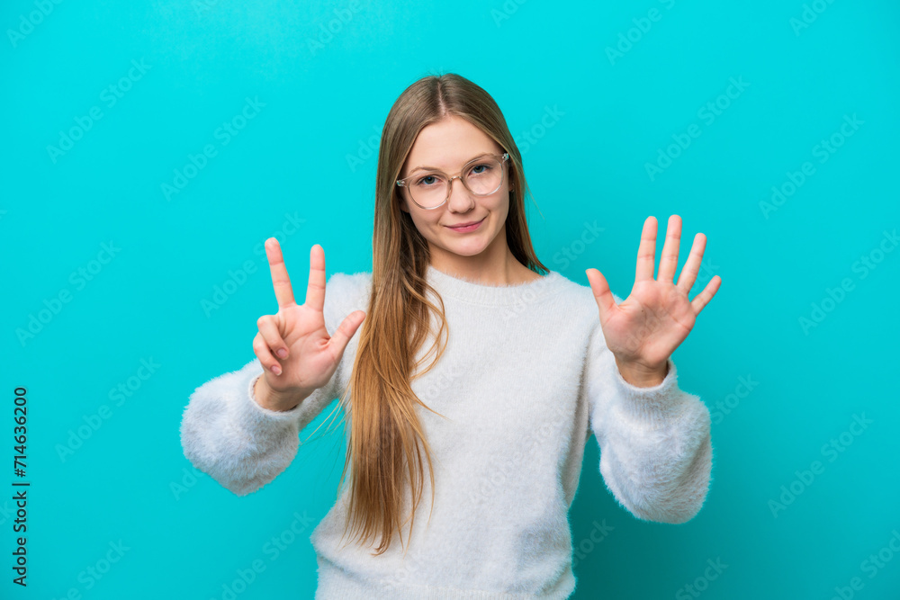 Young Russian woman isolated on blue background counting eight with fingers Young Russian woman isolated on blue background counting eight with fingers