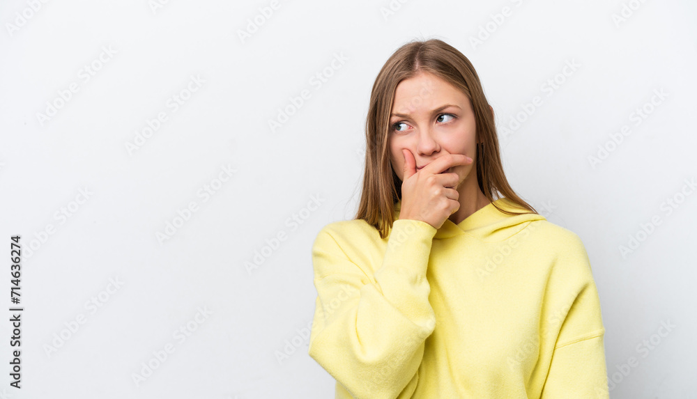 Young Russian woman isolated on white background having doubts and with confuse face expression Young Russian woman isolated on white background having doubts and with confuse face expression