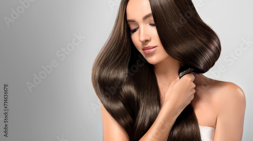 Beautiful model girl with shiny brown and straight long  hair . Keratin  straightening . Treatment, care and spa procedures. Smooth hairstyle
 photo