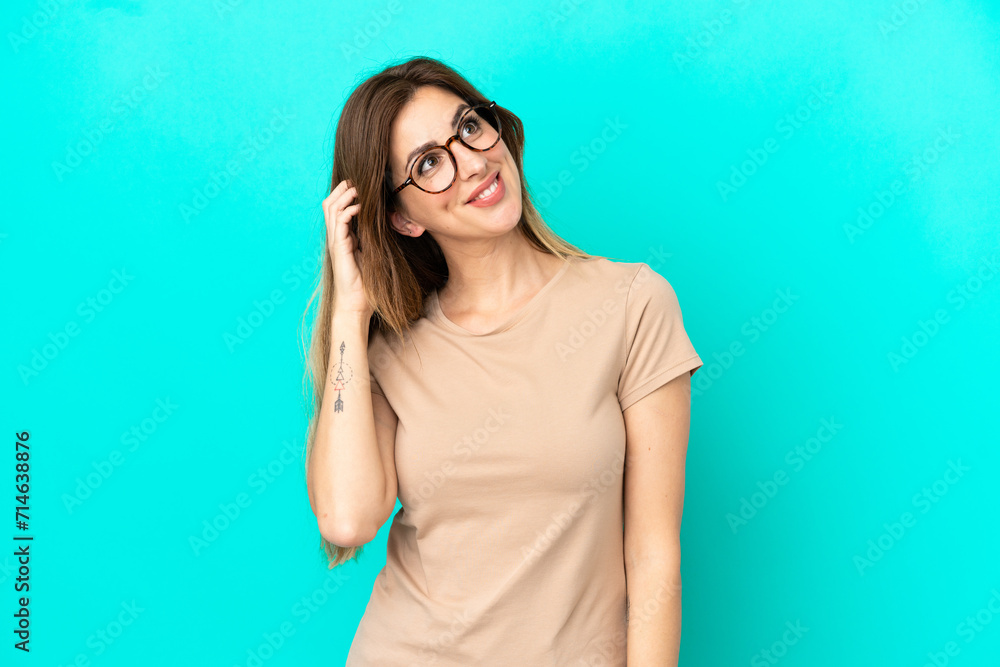 Young caucasian woman isolated on blue background thinking an idea Young caucasian woman isolated on blue background thinking an idea