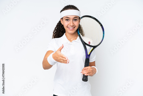 Young tennis player woman isolated on white background shaking hands for closing a good deal © luismolinero