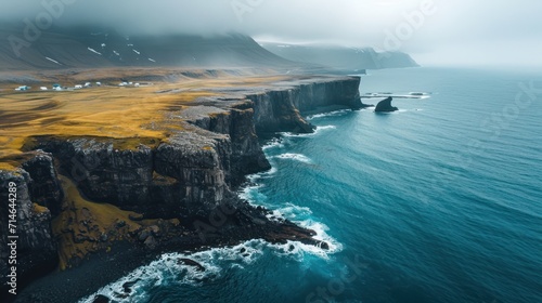  a large body of water next to a rocky cliff with yellow grass on top of it and a body of water on the other side of the cliff is a large body of water.