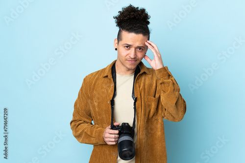 Photographer man over isolated blue background unhappy and frustrated with something. Negative facial expression photo