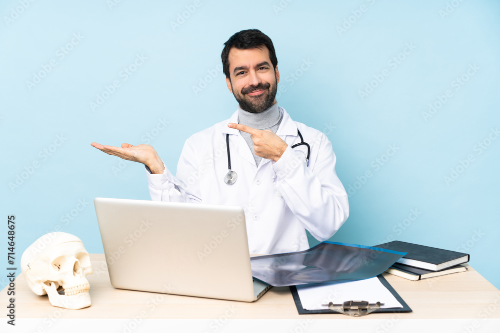 Professional traumatologist in workplace holding copyspace imaginary on the palm to insert an ad Professional traumatologist in workplace holding copyspace imaginary on the palm to insert an ad