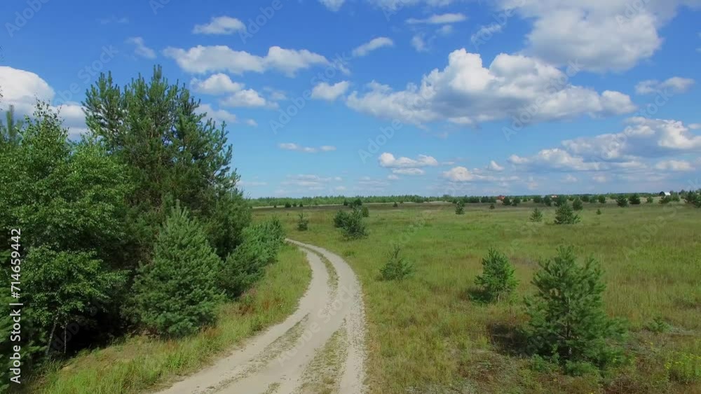 Country road along field near pond at summer sunny day. Aerial view Country road along field near pond at summer sunny day. Aerial view