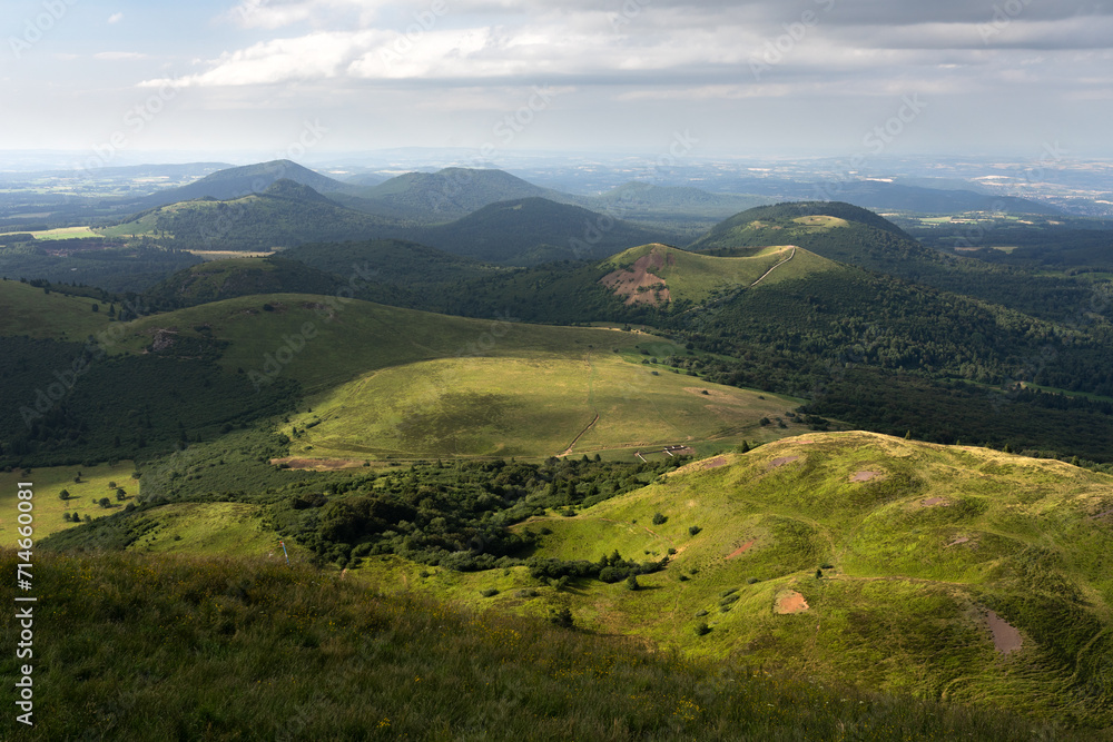 Auvergne vulcan since top of the Puy de Dome vulcan at sunset. Dramatic light landscape. Clermont Ferrand, France.