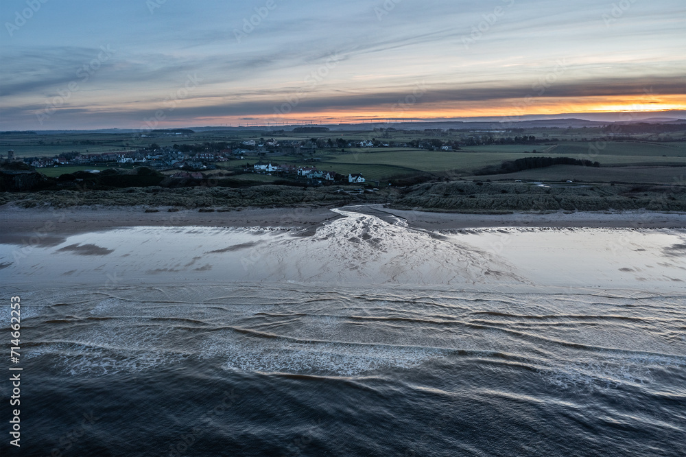 Stunning aerial drone landscape image of Northumberland beach in Northern England during Winter sunrise