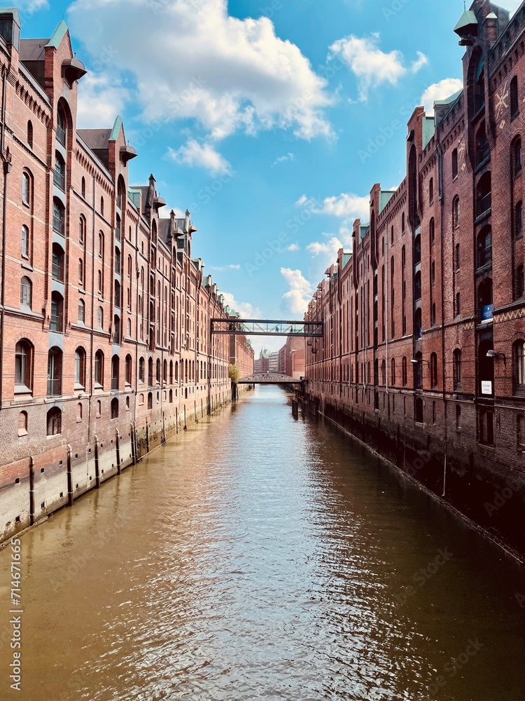 In this captivating photograph taken in Hamburg, a stunning cityscape unfolds as rows of elegant buildings stand in perfect symmetry along both sides of a waterway