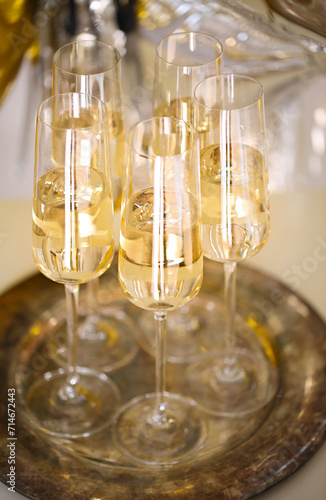 Close up of shiny glasses of champagne over party background