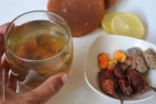 Asam jawa and kunyit or tam. Ussually used to make indonesian traditional herbal drink for women. jamu kunyit asam with the basic ingredients of turmeric and tamarind and other herbs. Selective focus.