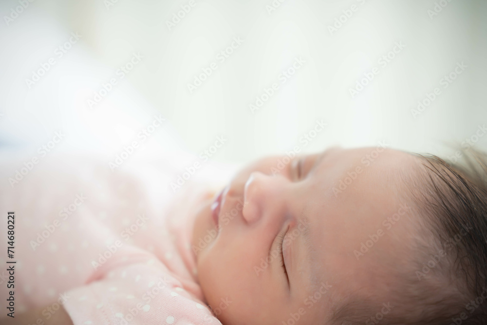 Close up Newborn Baby face Newborn Baby Girl sleeping on cozy bed Infant mixed race baby get sweet dream and good sleeping until morning Close up Newborn Baby face Newborn Baby Girl sleeping on cozy bed Infant mixed race baby get sweet dream and good sleeping until morning