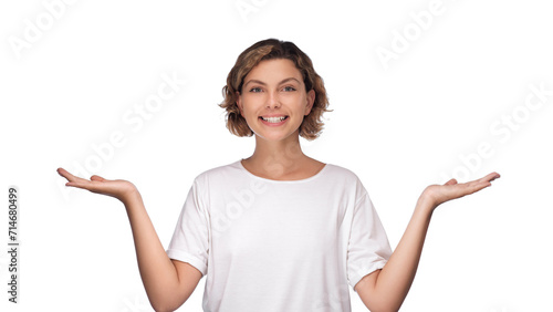 Choice, choosing, balance concept. Confused young woman holding something invisible on both palms, trying to choose something, holding hands up as scales, white studio background. High quality photo