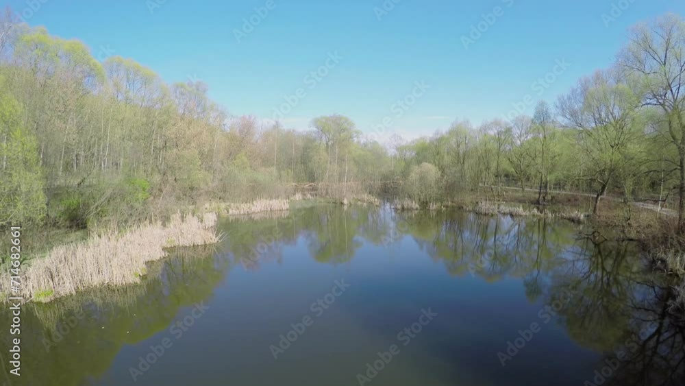 Backwater of Yauza river and wooden bridge among plants
Backwater of Yauza river and wooden bridge among plants