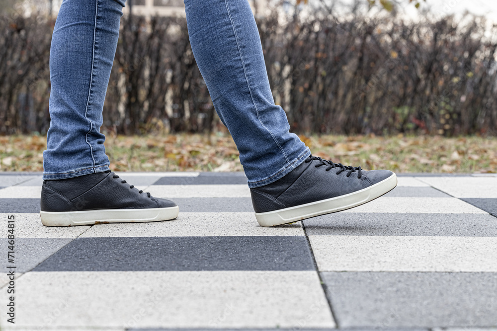 a man walks along a stone tile path a man walks along a stone tile path