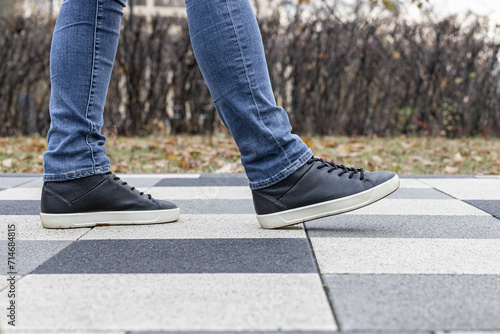 a man walks along a stone tile path