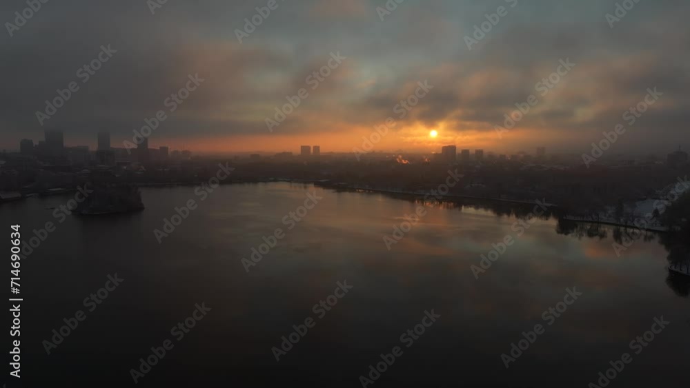 4K aerial video in Bucharest. Winter sunrise drone landscape from Herastrau park with amazing sky and its reflection in the lake. Travel to Romania.