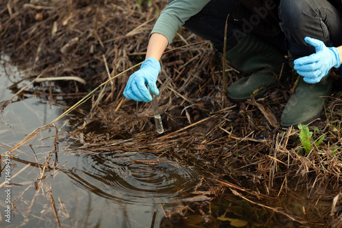 Female Biologist Working on Field Checking Mechanical Pollution of Water