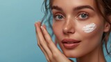 Hydration. Cream smear. Beauty close up portrait of young woman with a healthy glowing skin is applying a skincare product.