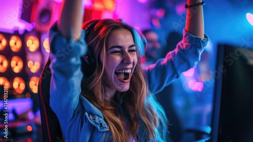Beautiful Friendly Pro teenager Gamer Girl Streaming Online Video Game and Winning it, Wearing Headset and Shares with Her Fans. Teenagers Having Fun. Background Cool Neon Retro Colors.