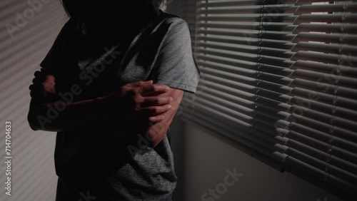 A woman ponders herself in a room, using her feelings to make judgments about personal and family issues. photo