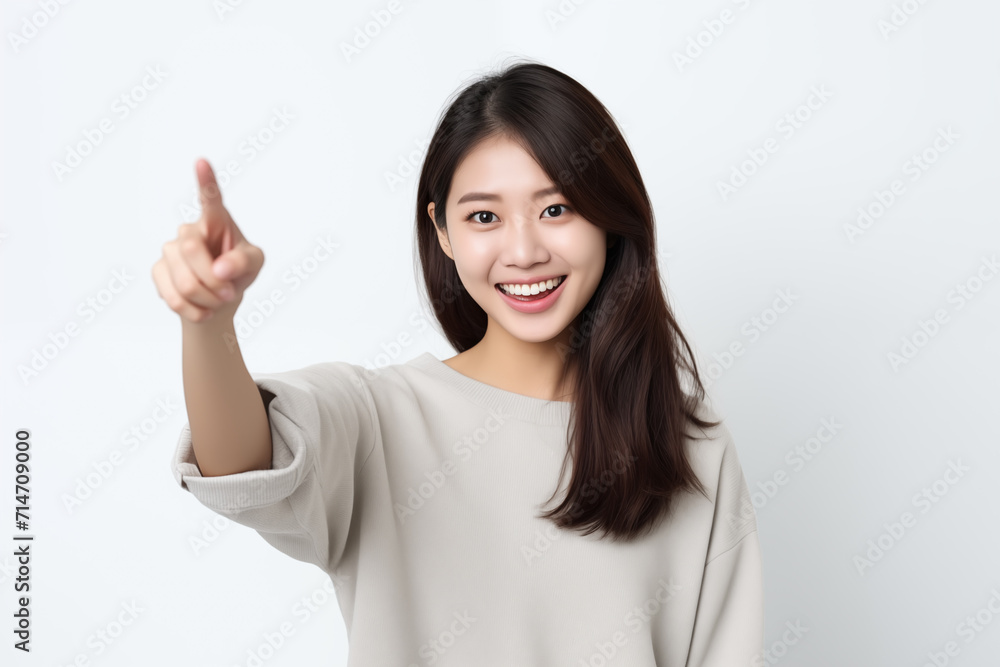 Japanese woman pointing in front of white background Japanese woman pointing in front of white background