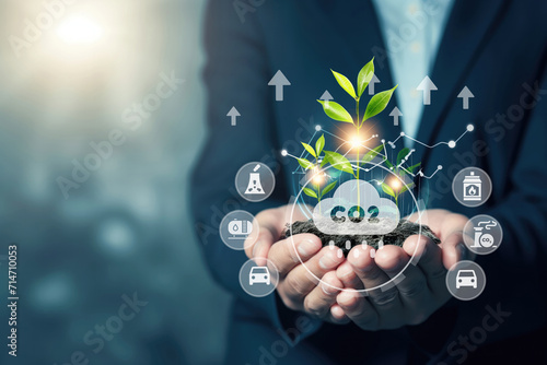 A glass globe with CO2 icons in the hands of a businessman. Reducing carbon emissions, carbon neutral concept. Net zero greenhouse gas emissions goal.Develop sustainable CO2 concepts. Reducing CO2 emi photo