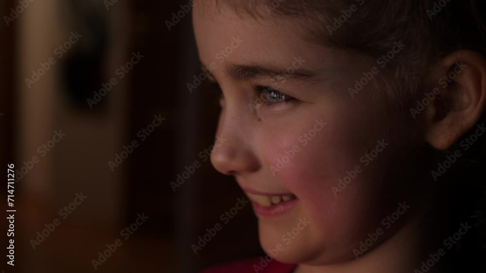 Child Watching Funny Cartoon Comedy on TV and Laughs. Child in Dark is Watching TV Playing Video Game. Close-up Face of Little Girl Kid Eyes. Video Game Entertainment Addiction Child Using Computer. Child Watching Funny Cartoon Comedy on TV and Laughs. Child in Dark is Watching TV Playing Video Game. Close-up Face of Little Girl Kid Eyes. Video Game Entertainment Addiction Child Using Computer.