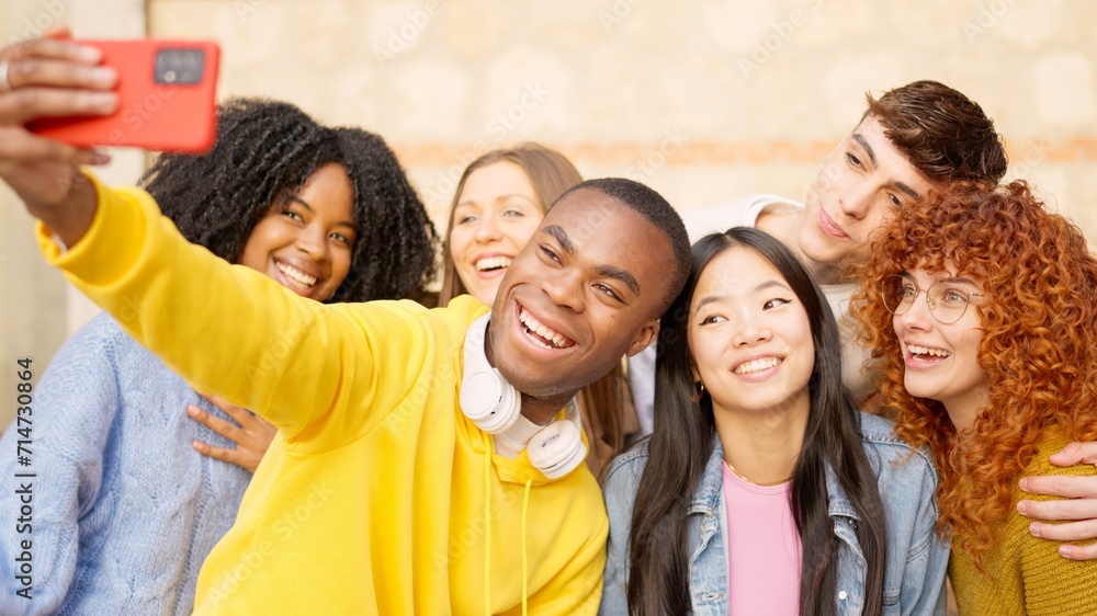 African man taking a selfie with multi-ethnic friends outdoors African man taking a selfie with multi-ethnic friends outdoors