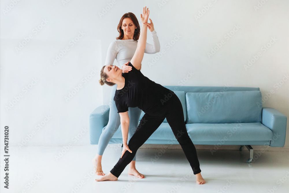 Fototapeta premium Women practicing yoga at home