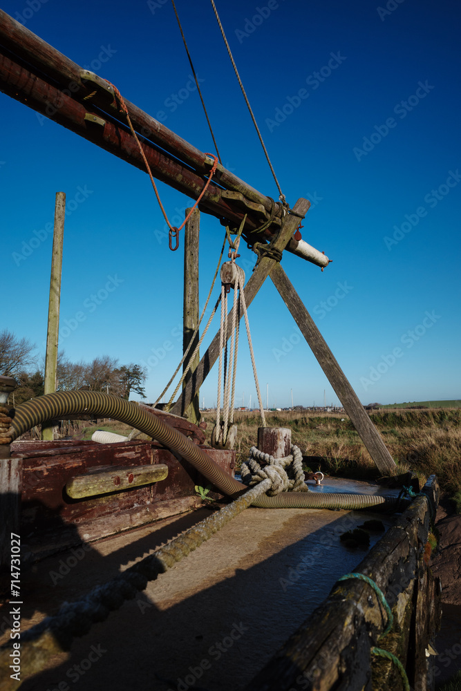 deck of old wooden boat with boom on a x stand