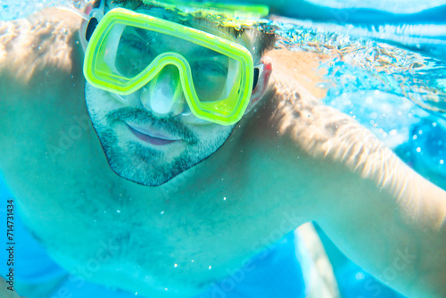 Man with snorkel mask underwater in swimming pool