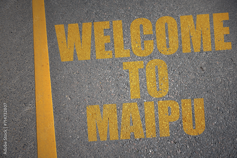 asphalt road with text welcome to Maipu near yellow line.