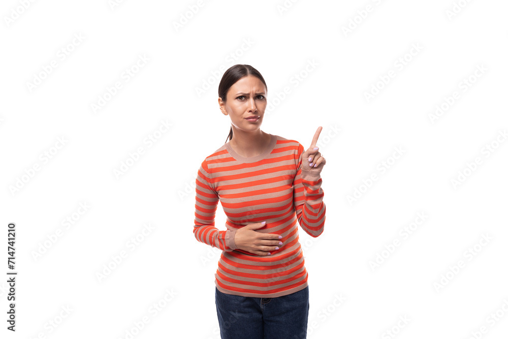surprised young adult woman dressed in an orange sweater holds her index finger to the side surprised young adult woman dressed in an orange sweater holds her index finger to the side