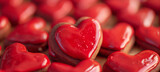 Glossy Red Heart-Shaped Candies Close-up. Close-up image of shiny red heart-shaped candies, perfect for expressing love and affection on Valentine's Day or other romantic occasions.