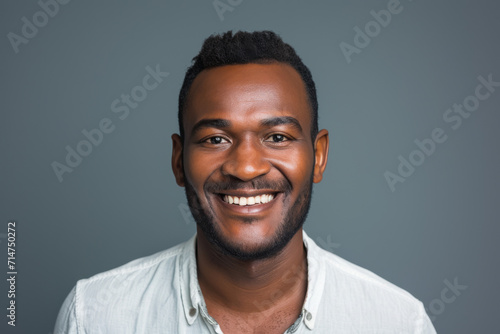A man in a white shirt is smiling for the camera