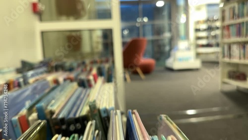 Wallpaper Mural Open book with fanned pages. Stack of hardback paper books on wooden bookshelves. Library bookcase in a row. Books stacking. Back to school. Education, reading moving forward along shelves Torontodigital.ca