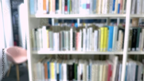 Open book with fanned pages. Stack of hardback paper books on wooden bookshelves. Library bookcase in a row. Books stacking. Back to school. Education, reading moving forward along shelves