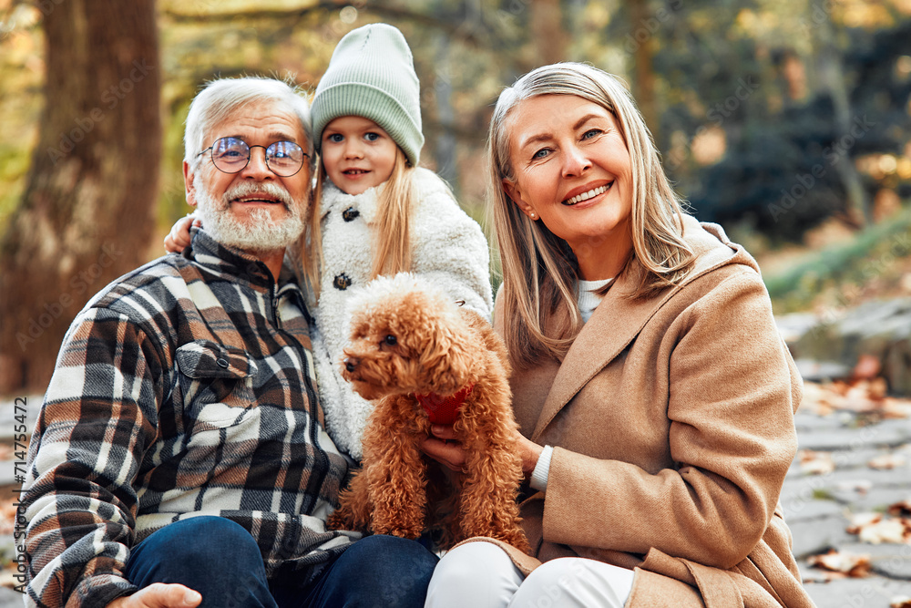 Senior couple walking in the park in autumn Senior couple walking in the park in autumn