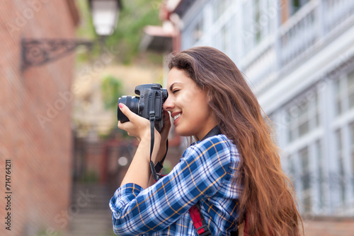 Outdoor summer smiling lifestyle portrait of pretty young woman having fun in the city in Europe