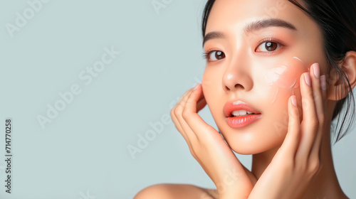 Asian woman applying anti age cream o resume touching her perfect skin face,  beauty skin care concept