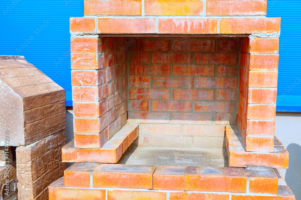 Fireplace made of bricks. Red brick oven